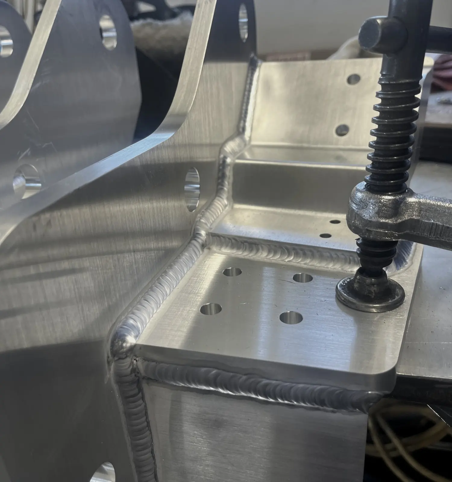 Aluminum part clamped in a welding fixture