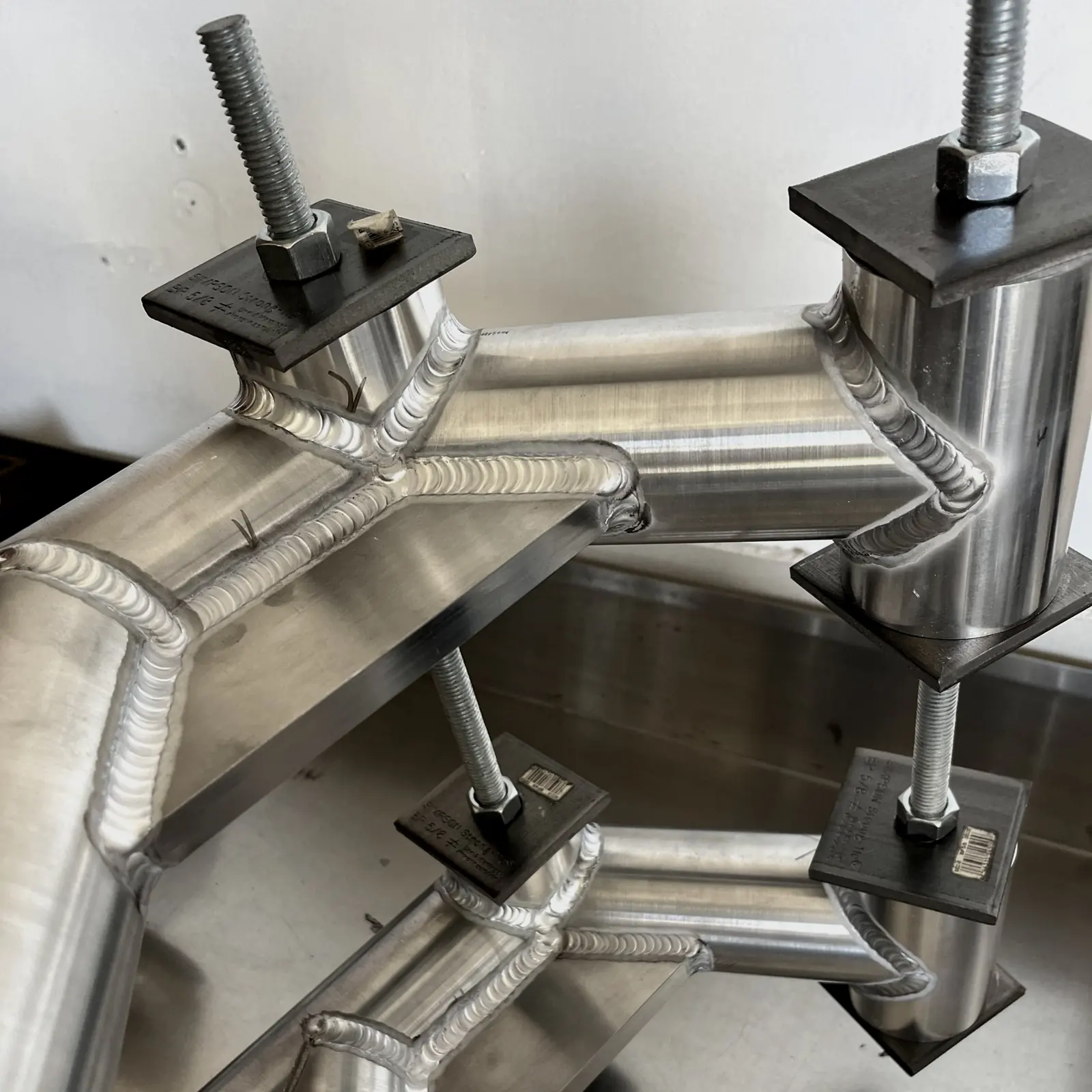 Aluminum tube node TIG welded while held in a fixture