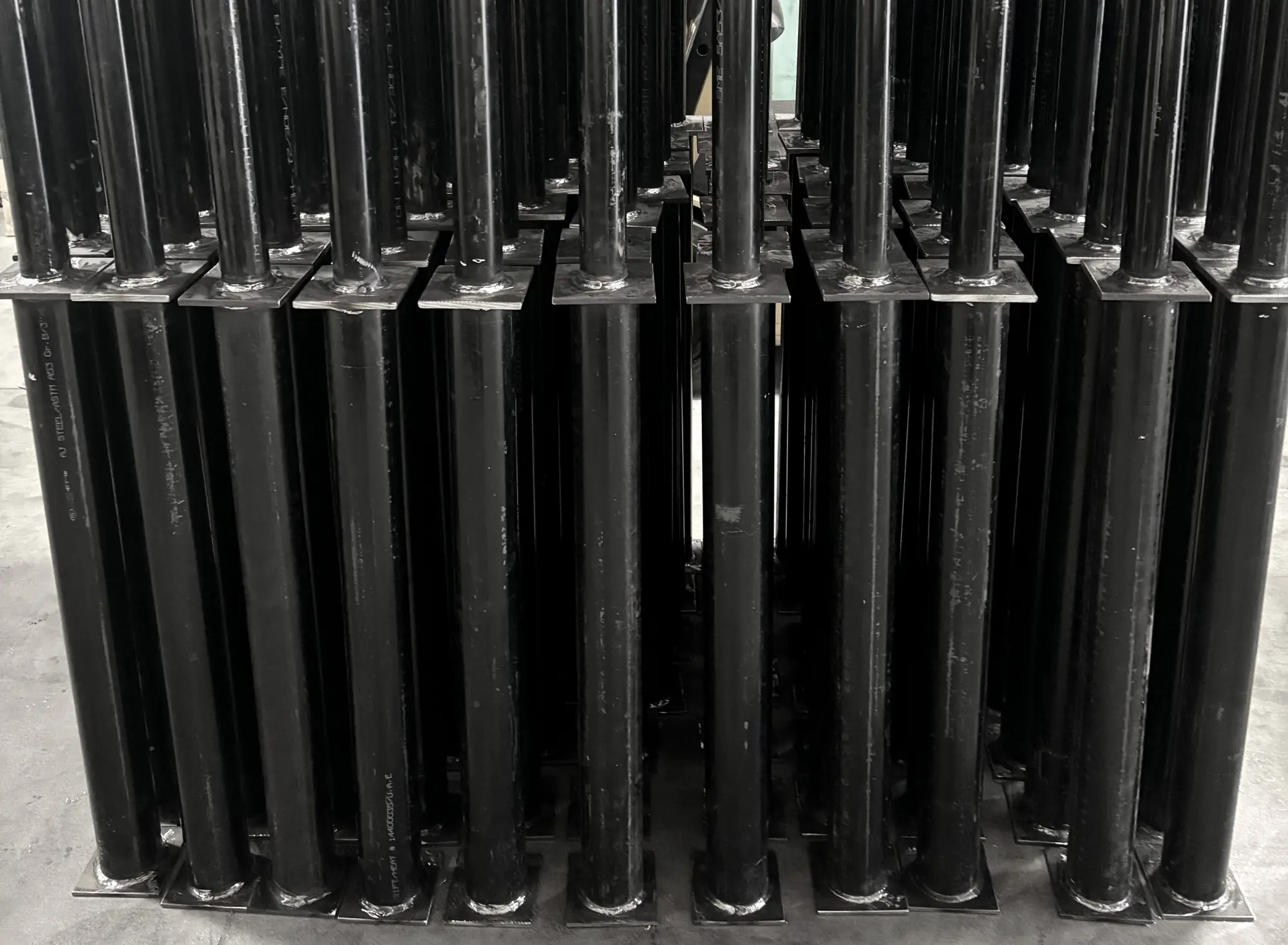 Wall of welded carbon steel post assemblies from a 130-piece run