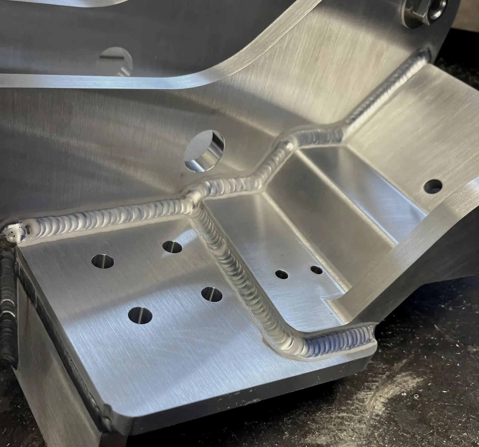 Aluminum bracket with long TIG welds