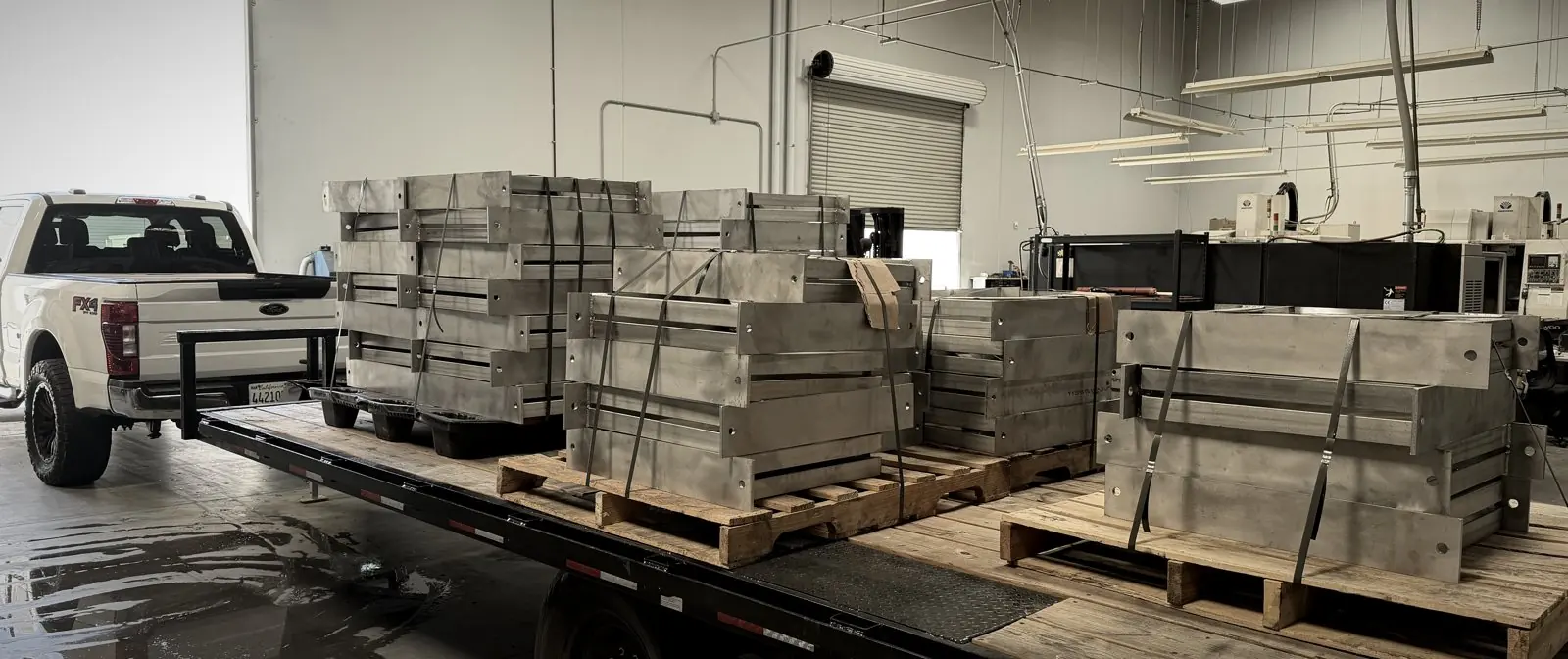Pallets of finished assemblies strapped on a trailer