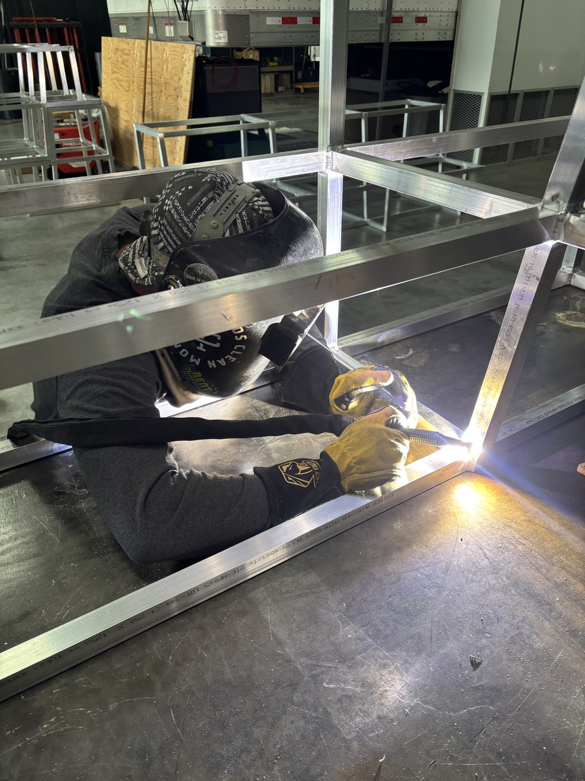 Jones welder fabricating an aluminum frame at a fixture table